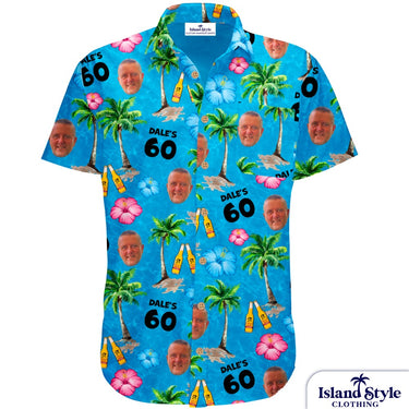 Blue Hawaiian shirt with palm trees, flowers, and a face printed on a white background