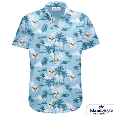 Hawaiian shirt with palm tree and eagle design on a light blue background with clouds.