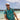 Man in a colorful shirt with a backpack on a beach