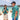 Two people in matching tropical-themed shirts on a beach with turquoise water and mountains in the background.