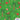 Patterned fabric with horses, palm trees, presents, and Christmas elements on a green background.