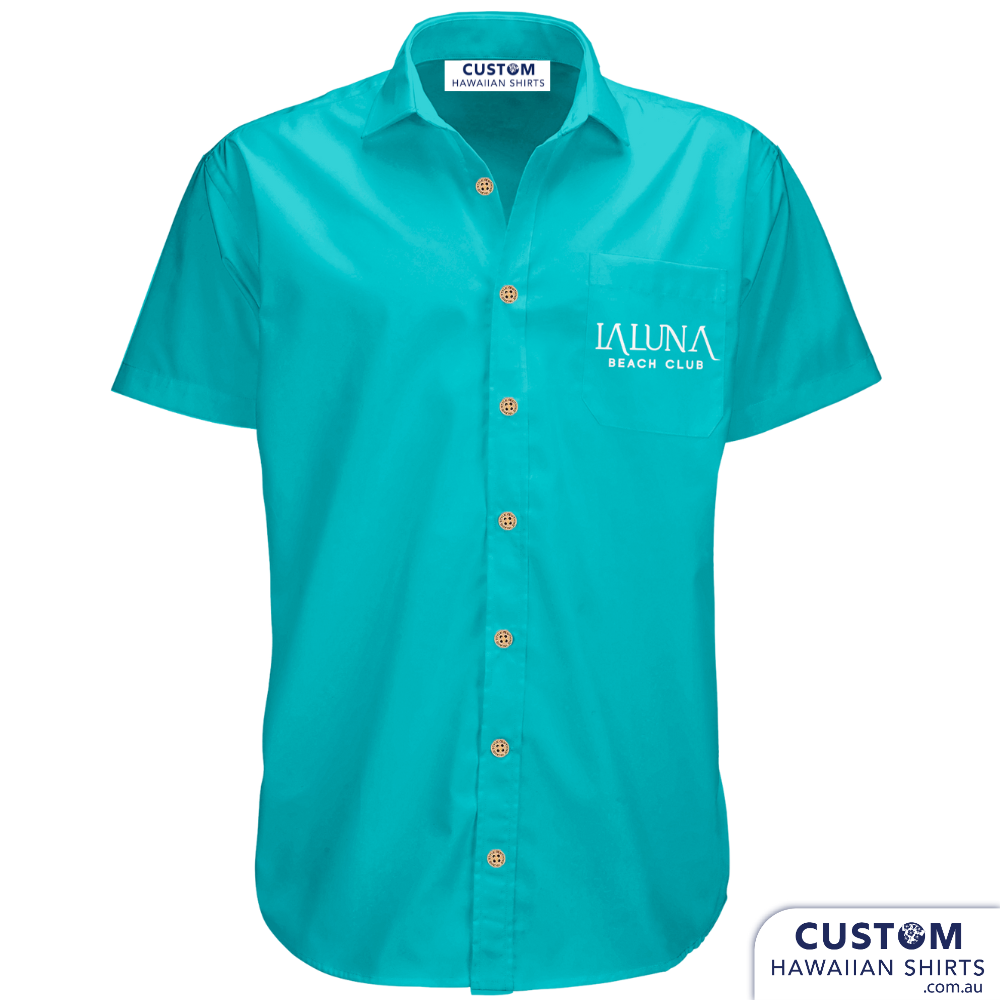 Bar and Hotel staff shirts custom-designed hospitality uniforms for La Luna Beach Club, GC. These personalised Hawaiian shirts were plain with their logo on the pocket.  Custom Hospitality Shirts 100% Cotton Open collar Logo on pocket Blue & Tan version Coconut buttons Free design by our in-house designers on Sunny Coast
