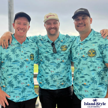 Three men wearing matching blue patterned shirts with a brand logo, standing outdoors.