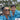 Two women wearing blue tropical shirts with sunglasses in a golf course setting.