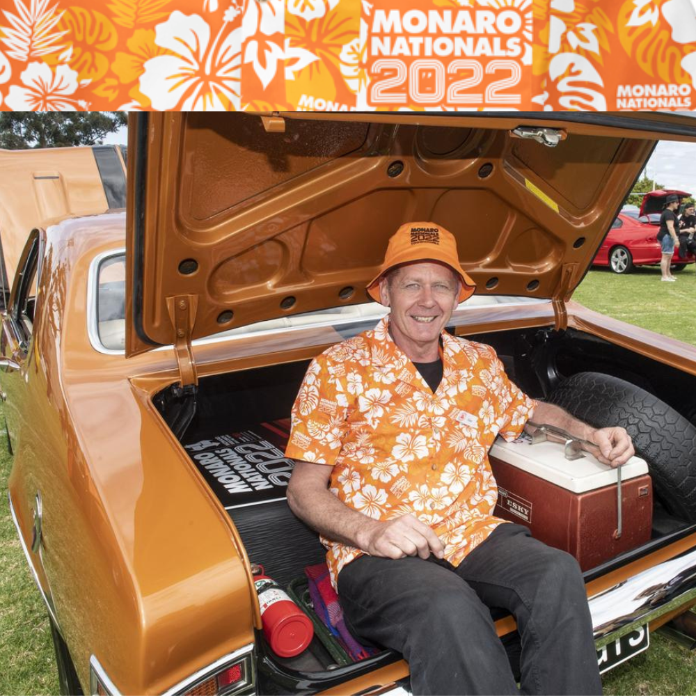 Custom Hawaiian Shirts for Monaro Nationals 2022. An orange base with classic hawaiian flowers, hibiscus, palms leaves and their logo. Personalised for this event.